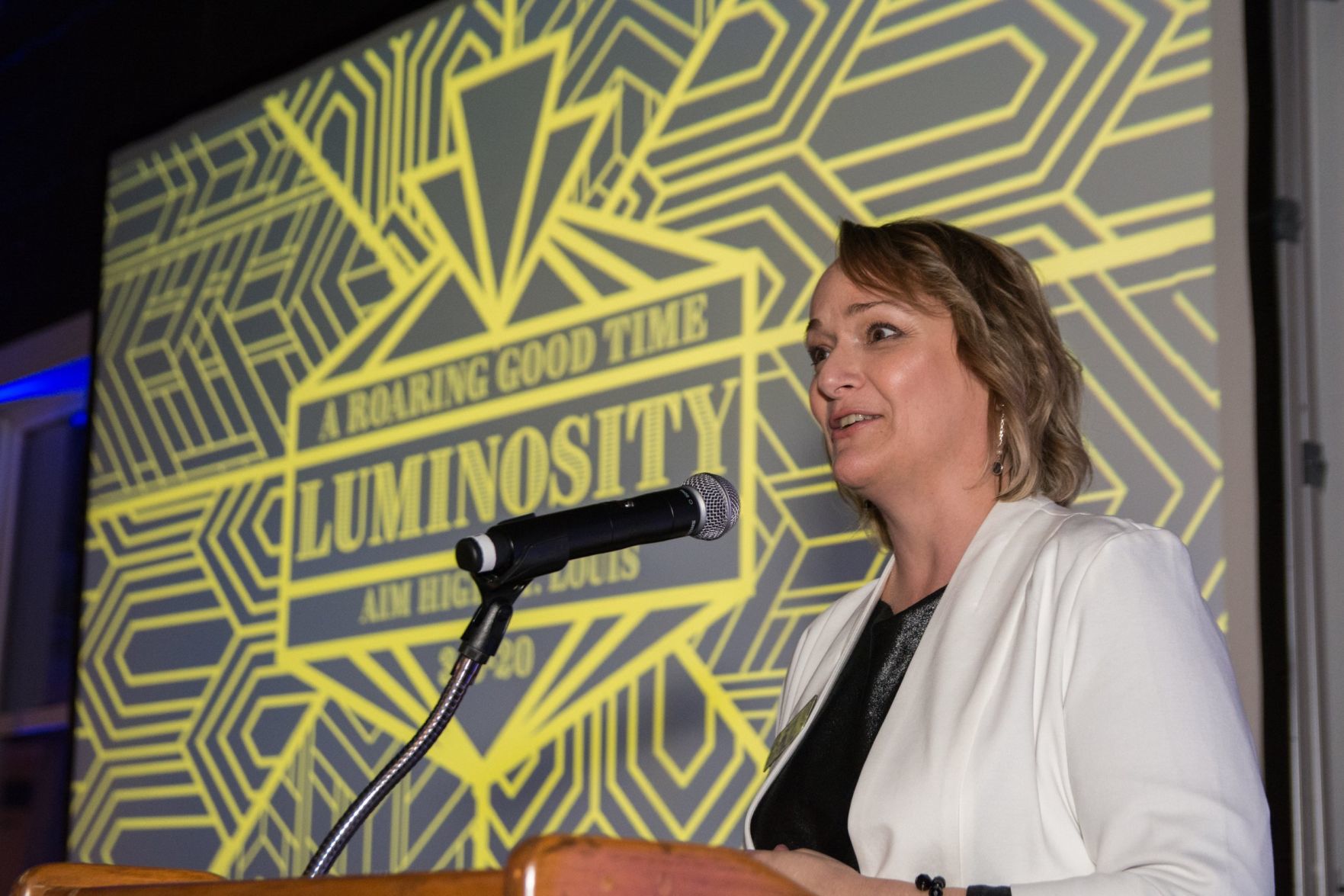 Julie Angelica, Executive Director, Aim High St. Louis speaks at the event